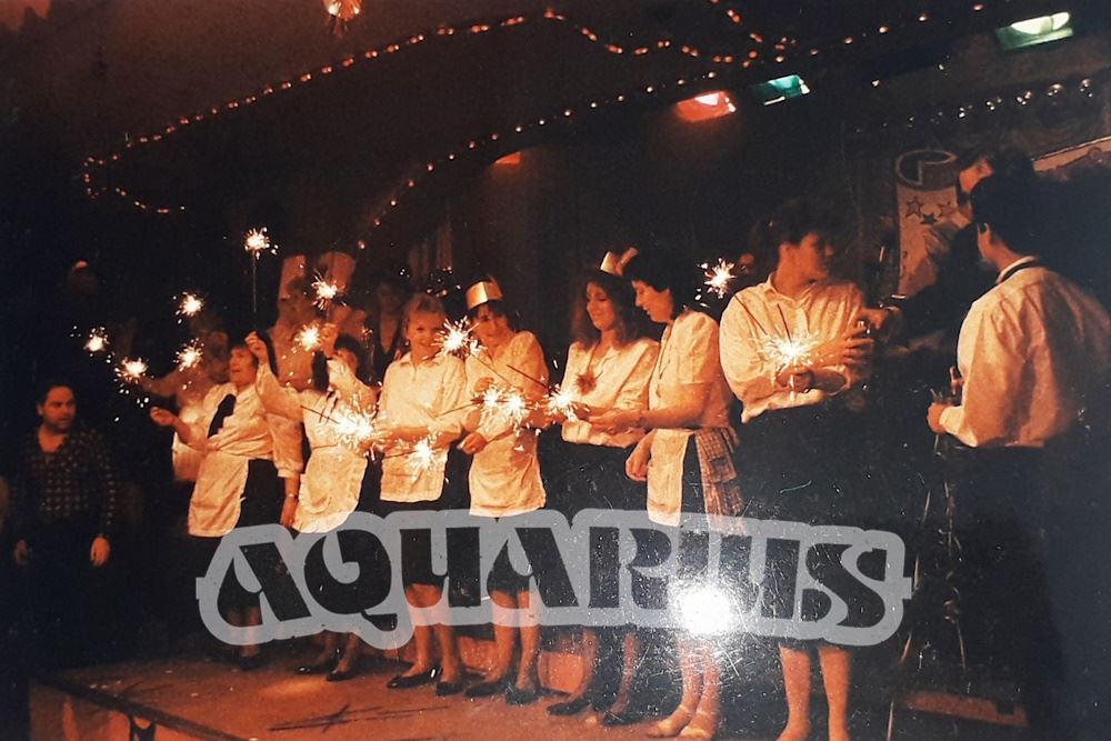 Waiting staff on stage, possibly celebrating New Year's Eve