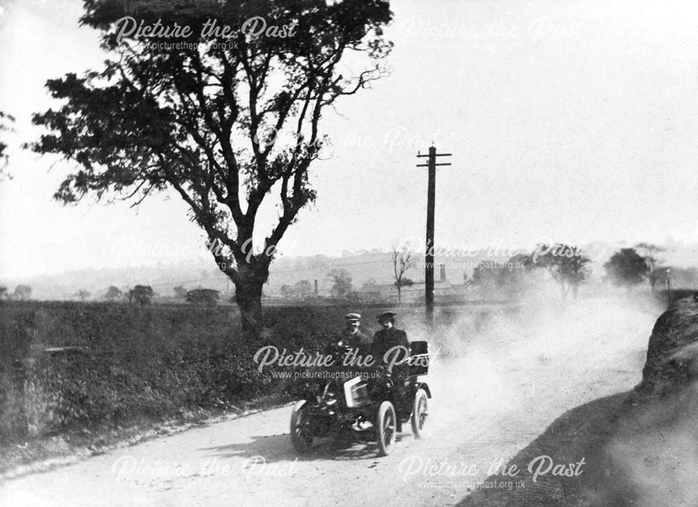 Mr W Ralph Bates in an early Motor Car, travelling at 14mph on Furnace Terrace
