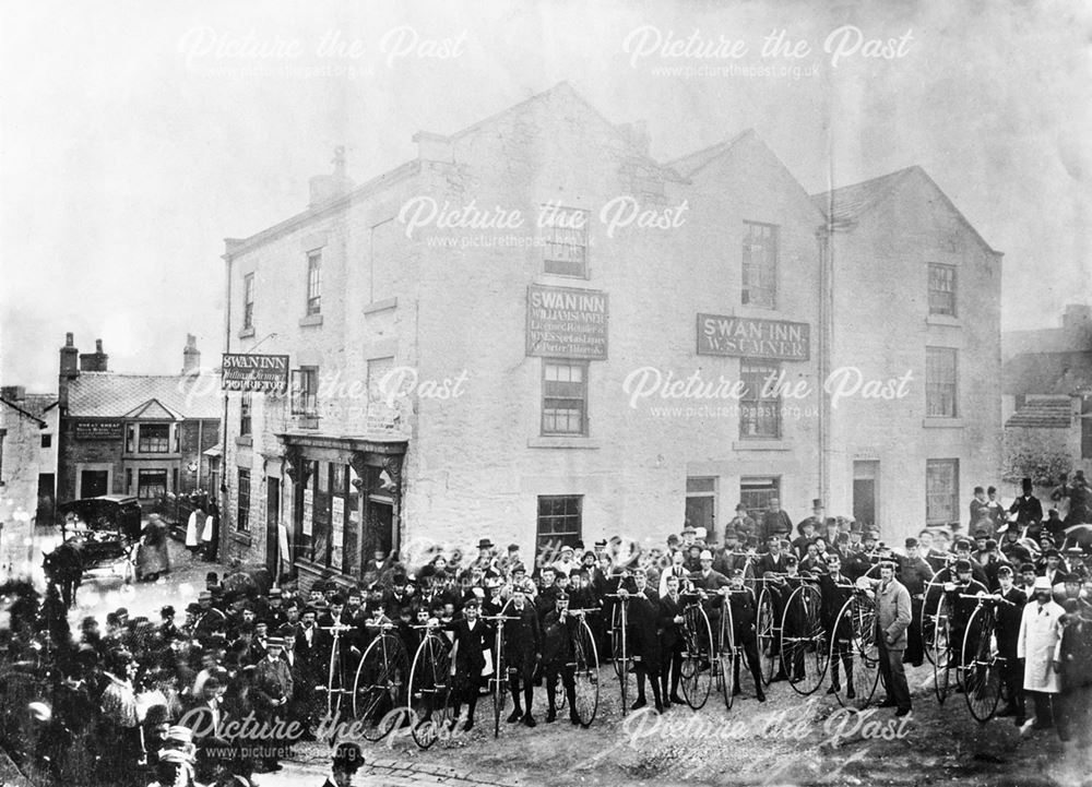 People and Penny Farthing bicycles outside the Swan Inn