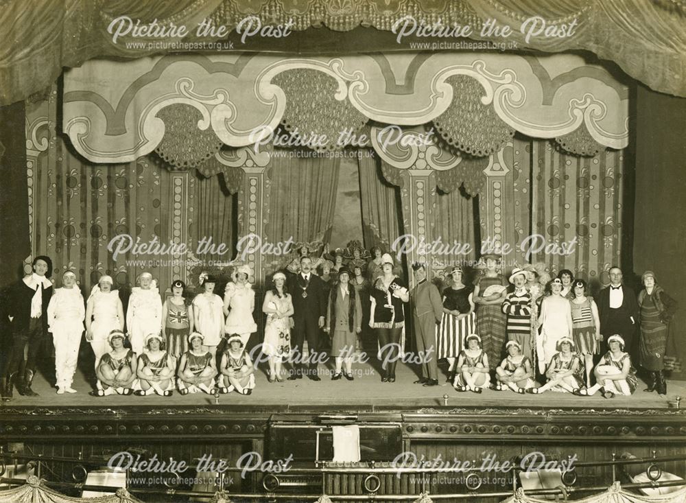 Theatrical cast members on stage