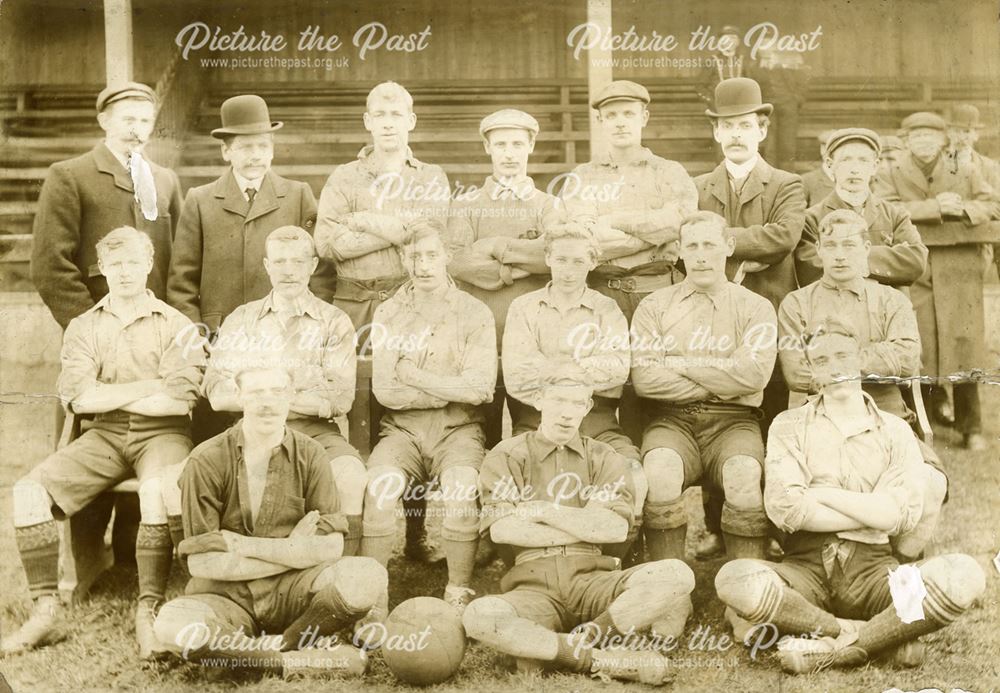 Unknown football team posing in front of stand