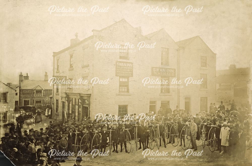 People and Penny Farthing bicycles outside the Swan Inn