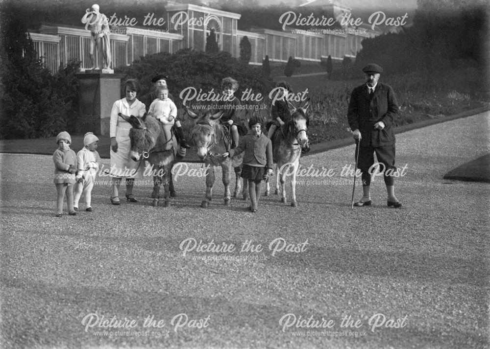 9th Duke of Devonshire with some of his grandchildren riding donkeys in Chatsworth's gardens, 1928