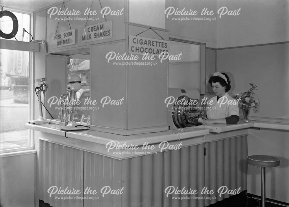 Assistant at counter in Ice-cream parlour, Spring Gardens, Buxton                                   