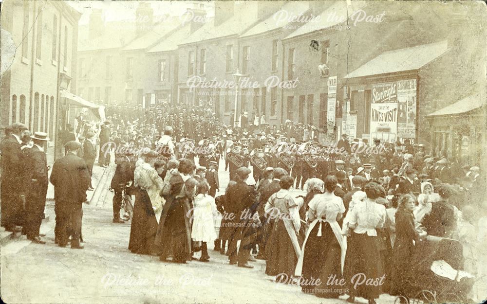 Unidentified event showing a band and men in uniform marching through a Shirebrook Street