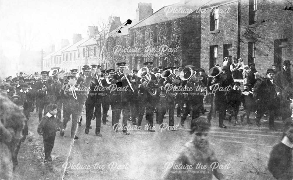Unidentified event showing a band and men and boys in uniform marching through a Shirebrook Street