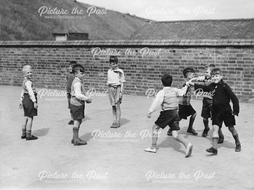 Boys doing country dancing in the top Playground, Carter Lane School, Shirebrook