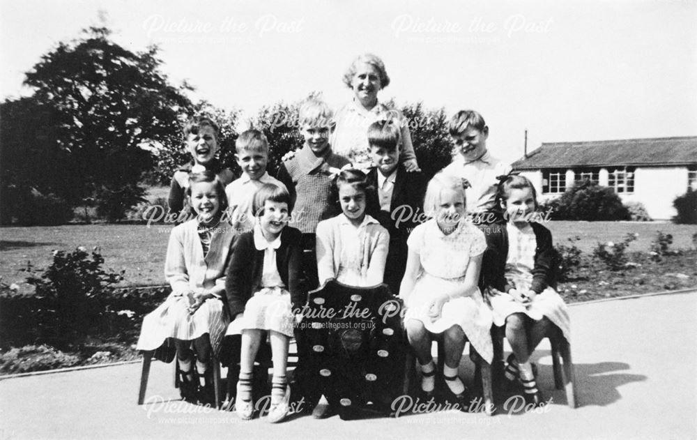 School children and teacher with shield, Shirebrook, c 1950s