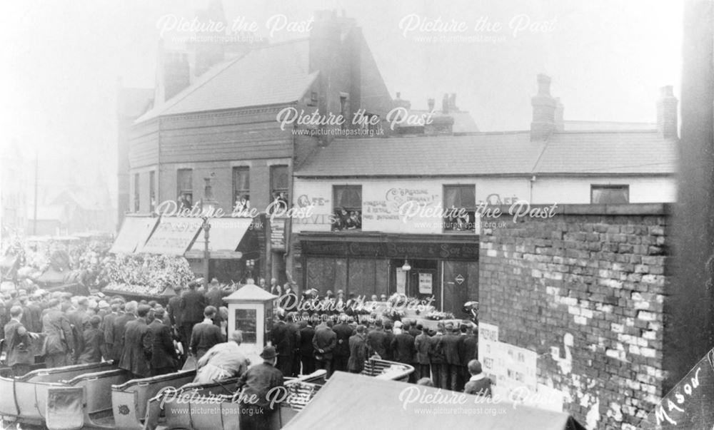 Charles Markham's Funeral passing Frisby's Boot Store and Connie Brook's Cafe and Butchers