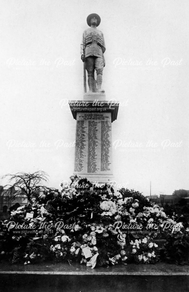 Staveley War memorial (after a memorial service, showing flowers and wreathes)