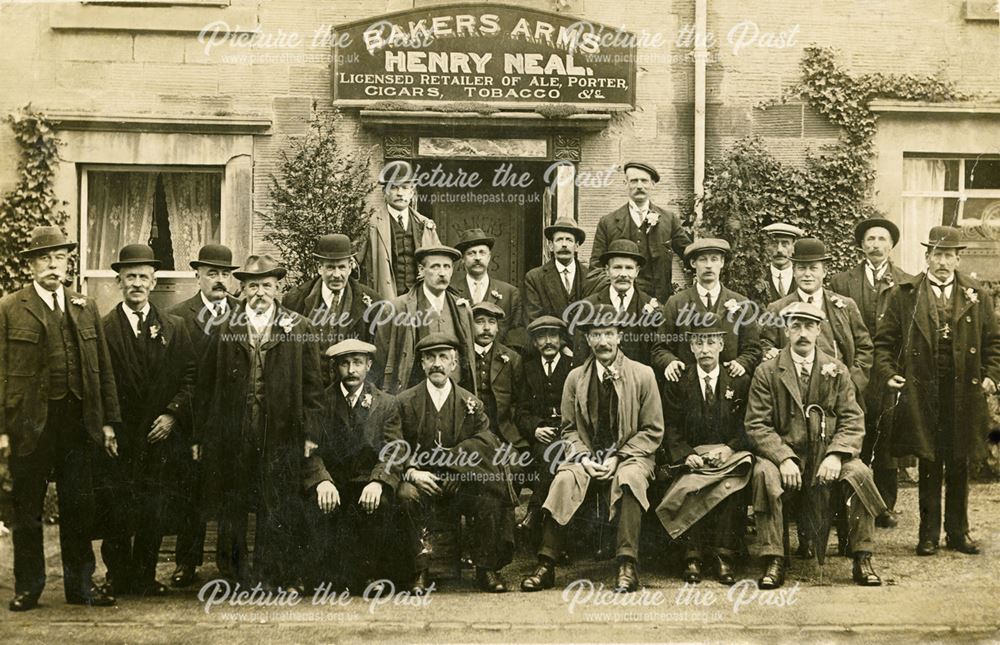 Group of men outside the Bakers Arms public house