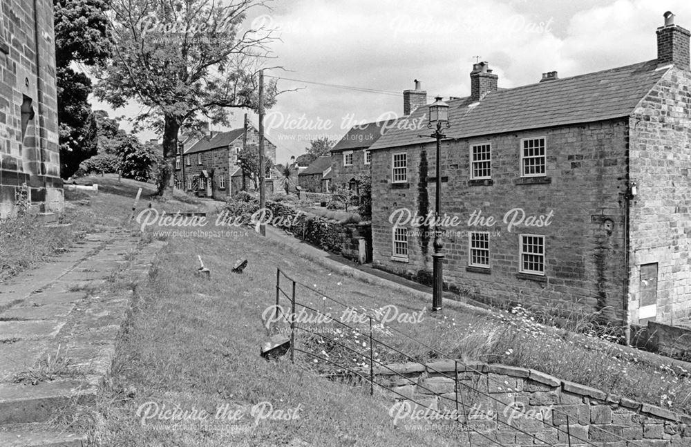 Row of cottages overlooking church