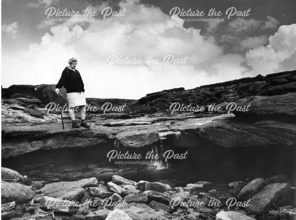 A hiker at the top of Kinder Downfall