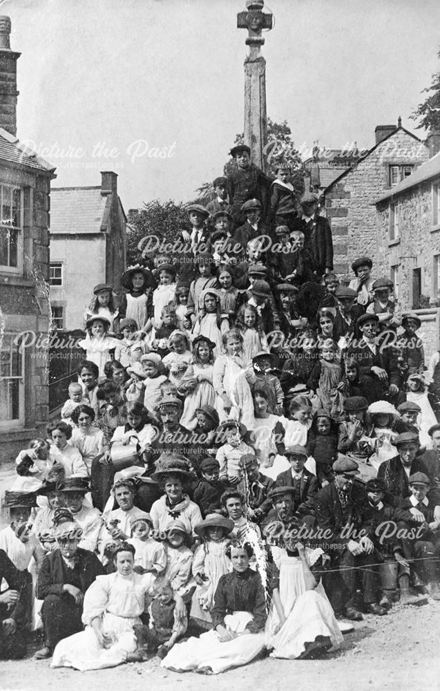 Villagers gathered around Bonsall Cross, c 1900