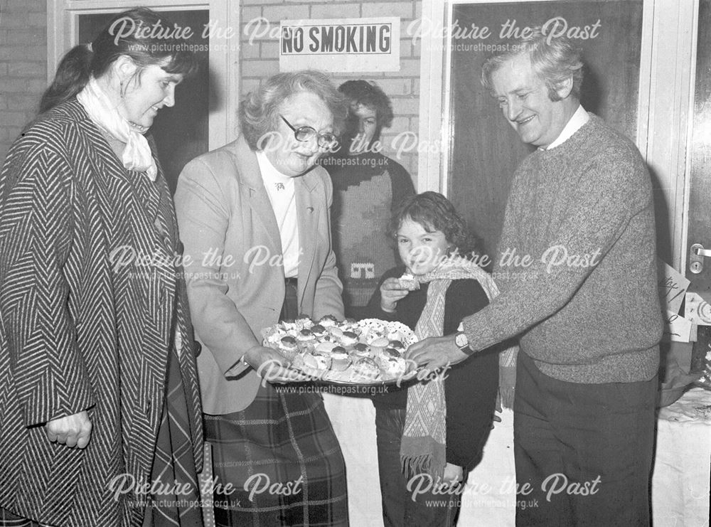 Lady handing out Sticky Buns, Ilkeston, c 1980s