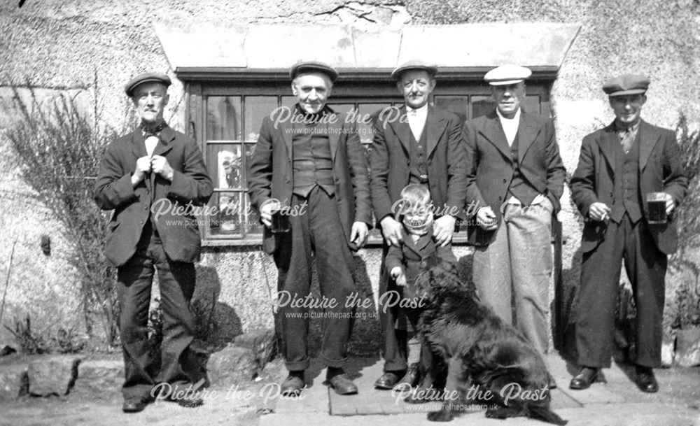 Group of men, boy and dog at the rear of The Blue Stoops public house, High Street, Dronfield, 1935