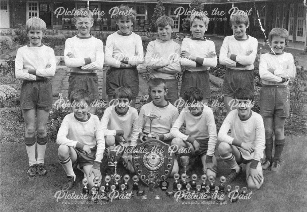 Boys School Football Team with trophies