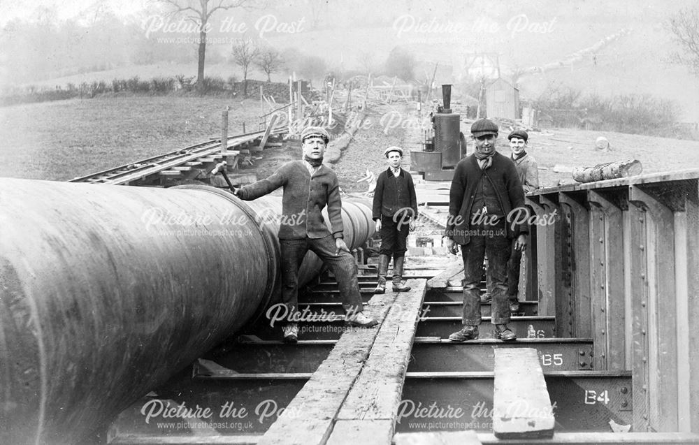 Workers beside a pipe leading from Ambergate Reservoir