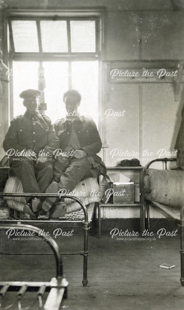 Vic Fewkes of Bakewell, and another soldier sitting on an army bed