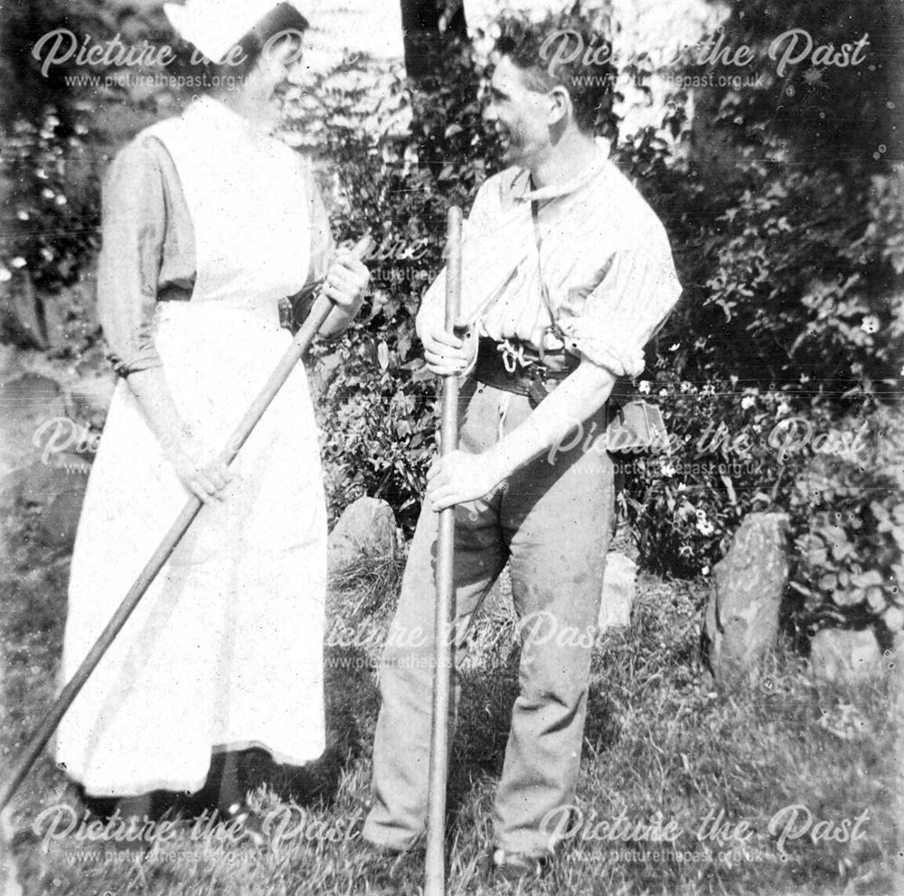 Recovering soldier and nurse tending a garden