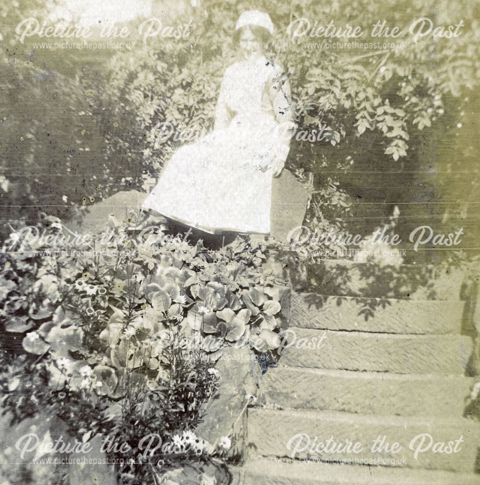 Nurse sitting on the steps in the grounds of the Derby Royal Infirmary