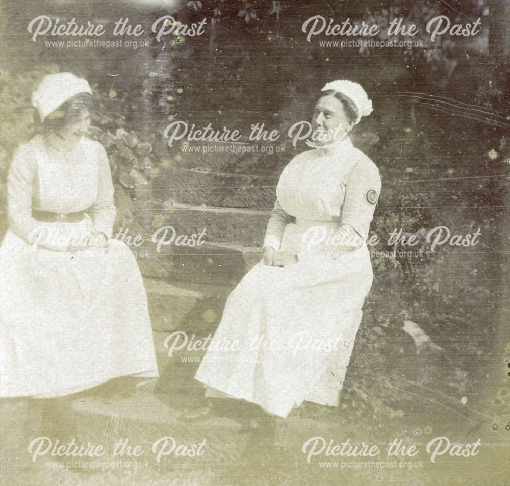 Nurses sitting on the steps in the grounds of the Derby Royal Infirmary