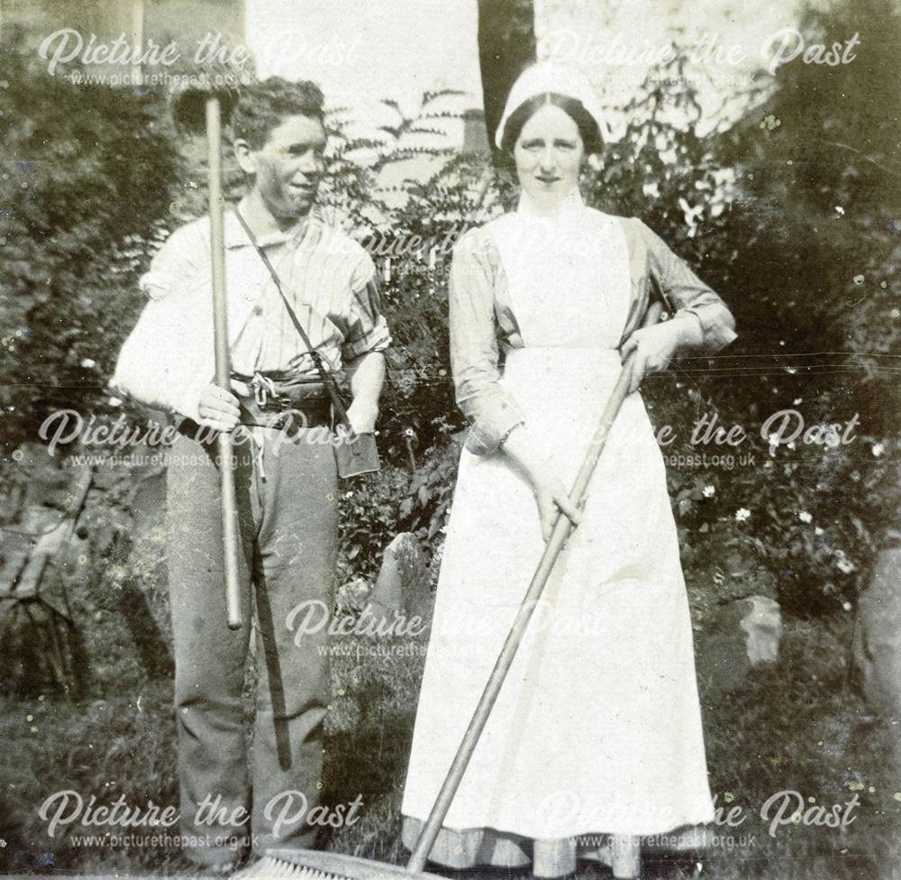 Nurse and recovering soldier tending a garden
