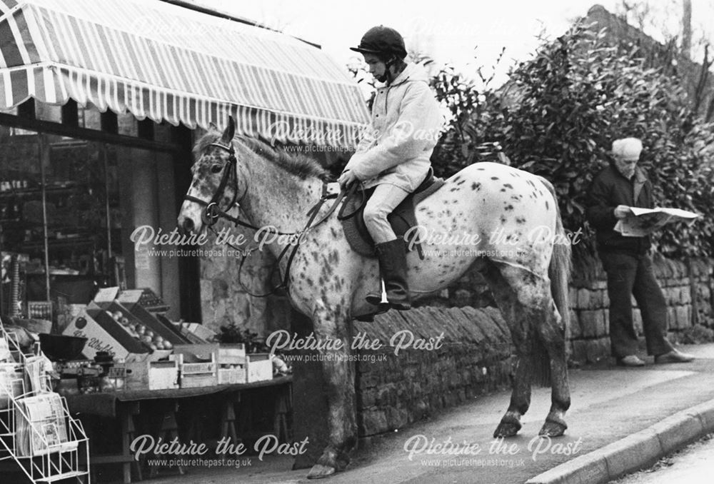 Horse and rider outside the Cottage Stores, Holymoorside, c 1988