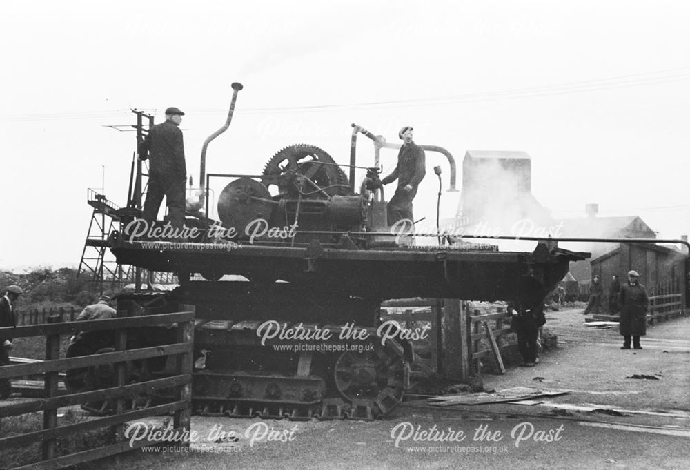 Unloading an excavator from a railway engine at Stanton Old Works