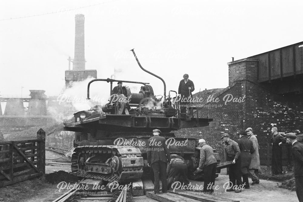 Unloading an excavator from a railway engine at Stanton Old Works