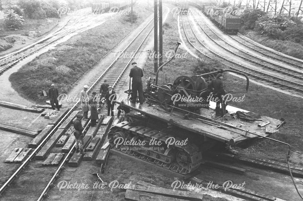 Unloading an excavator from a railway engine at Stanton Old Works