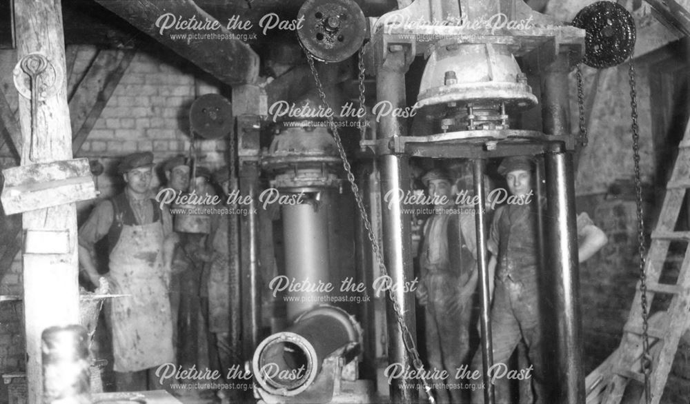 Pipe making machines and workmen at the brick and sanitary pipe works of W H and J Slater, Denby