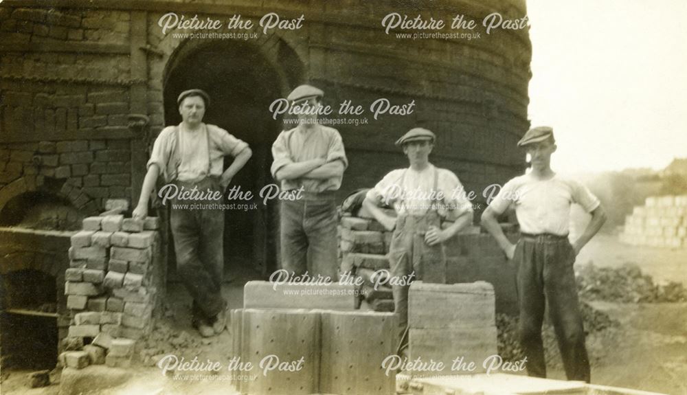 A kiln gang by a round down-draught kiln at the brick and sanitary pipe works of W H and J Slater, D