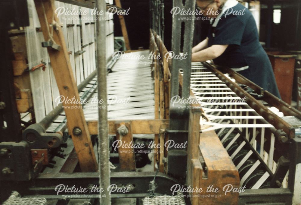 Woman operating a Multi-shuttle Loom at Lilley's Narrow Fabrics, Washington Mill, Borrowash