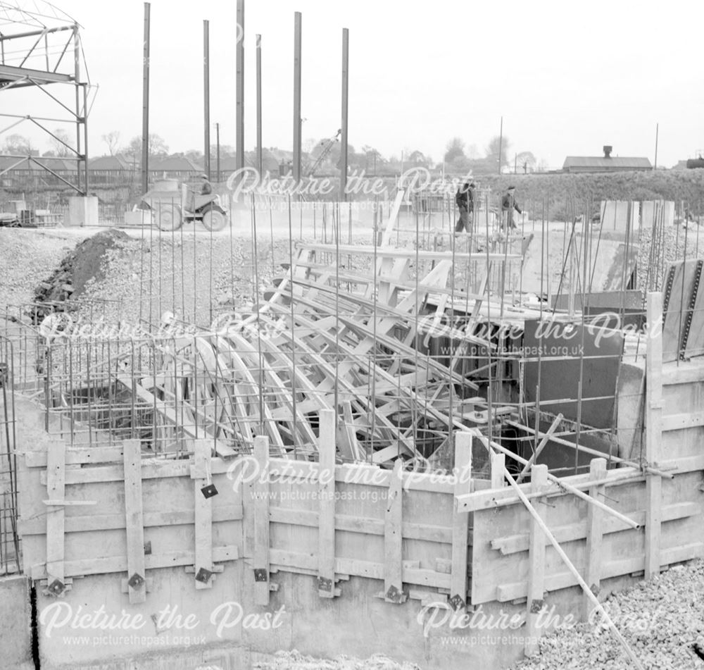 Construction of Ore Preparation Plant - steel framework at the base of the plant's chimney