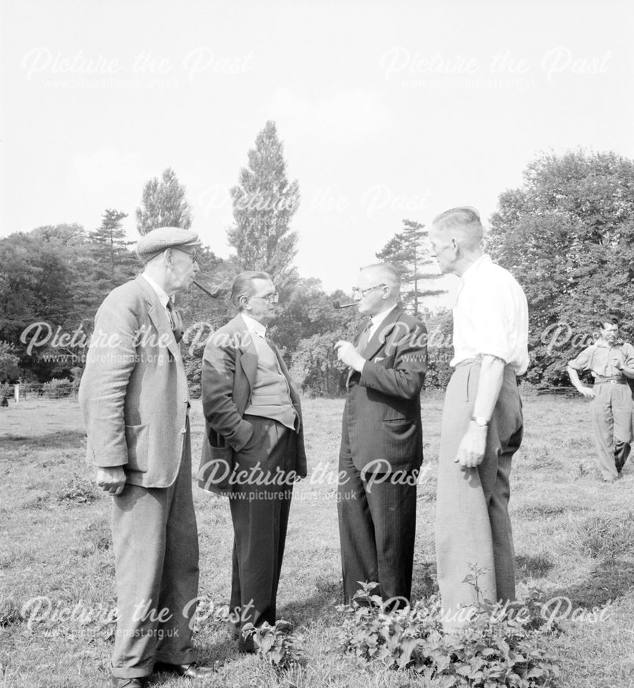 Men conversing (with pipes) at a Stanton Works Annual Flower Show