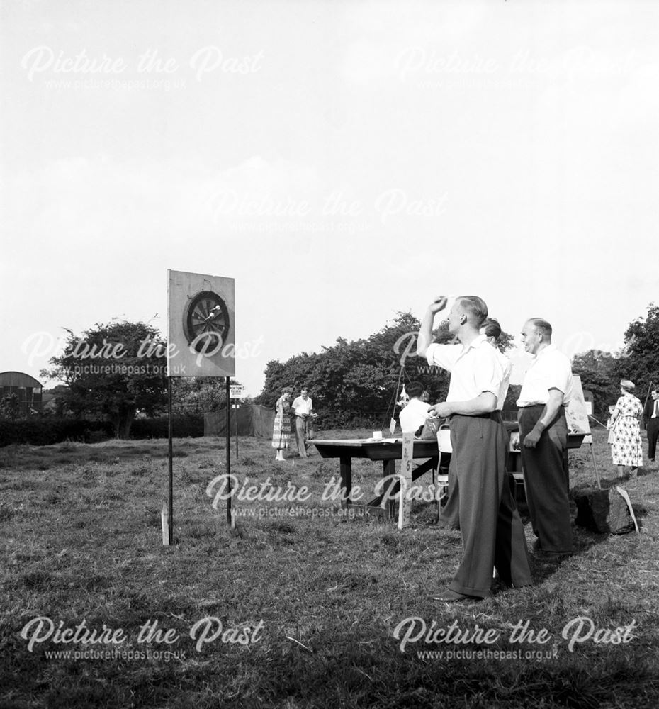 Men playing darts at a Stanton Works Annual Flower Show