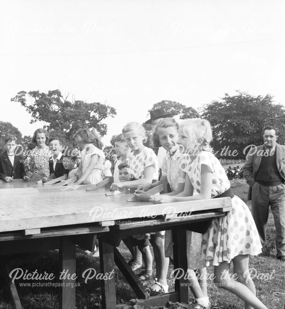 A group of girls playing 'Roller Penny' at a Stanton Works Annual Flower Show