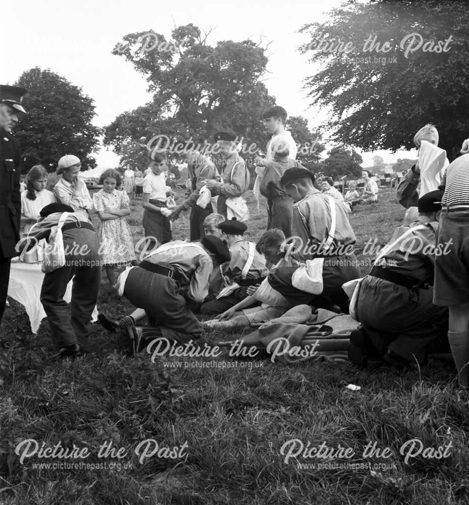 A group of Boy's Brigade or St John's Ambulance members demonstrating first aid at a Stanton Works A