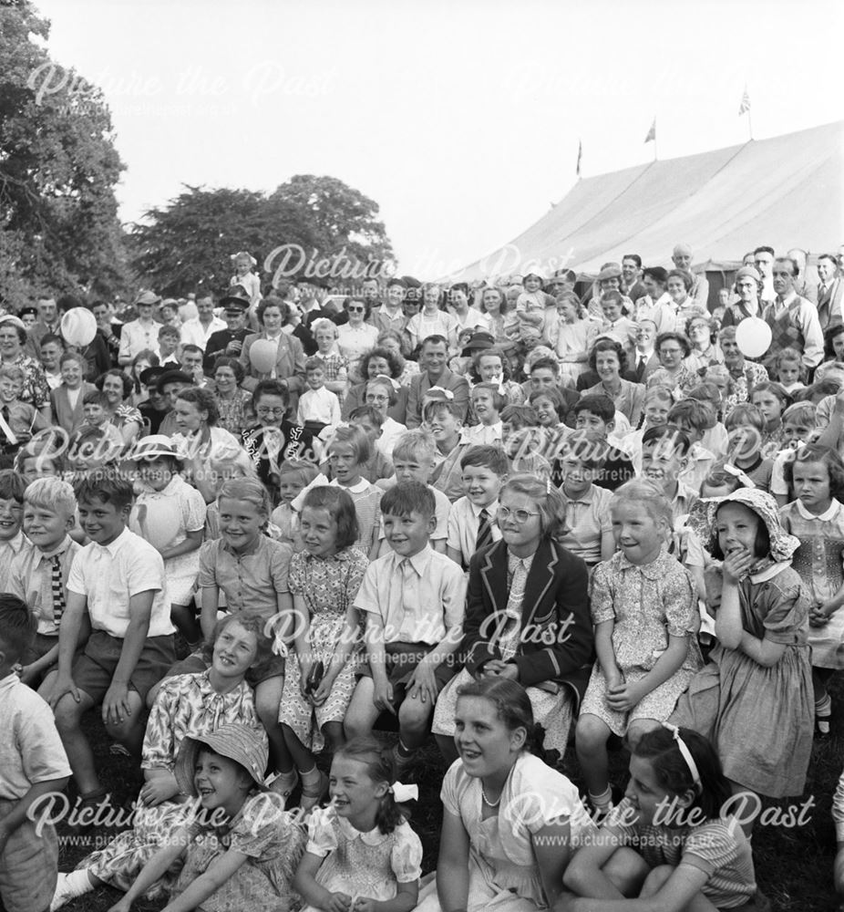 A large group of children (watching the Punch and Judy show ?) at a Stanton Works Annual Flower Show