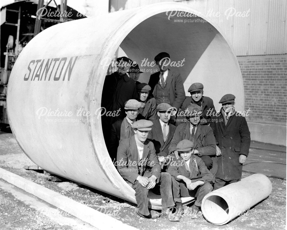 Workmen inside a concrete pipe