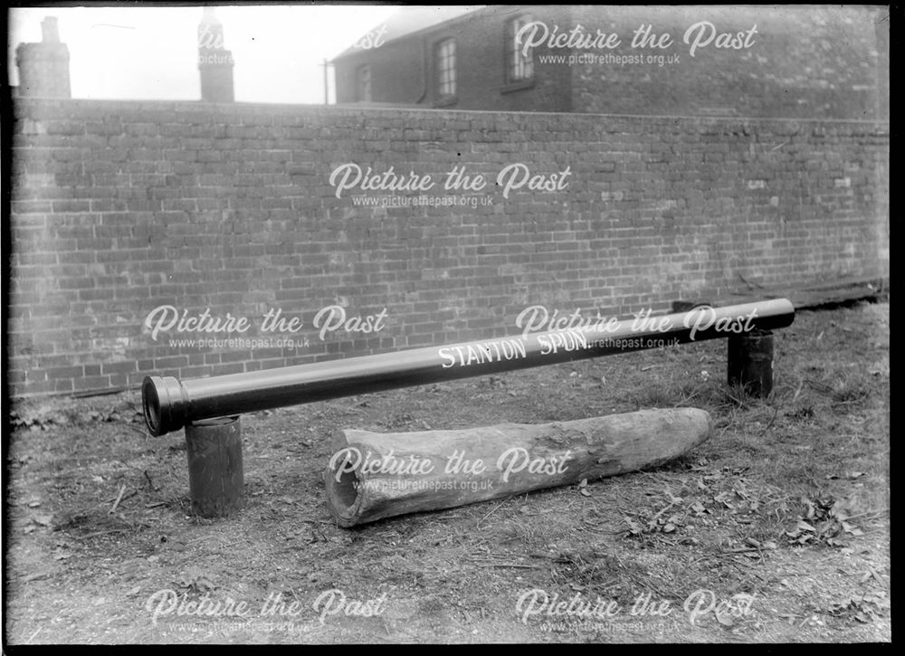 Comparison between a spun iron pipe and an old wooden pipe