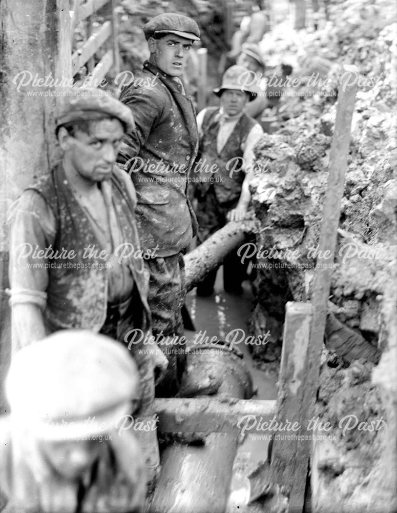 Workmen laying a gas main