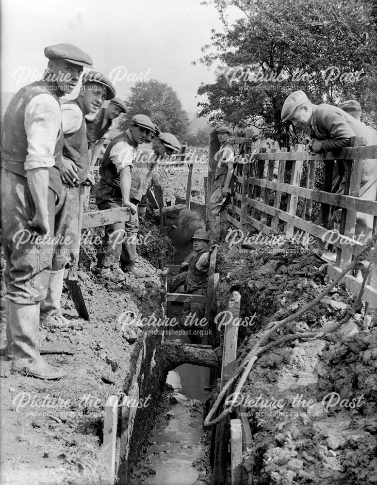 Workmen laying a gas main