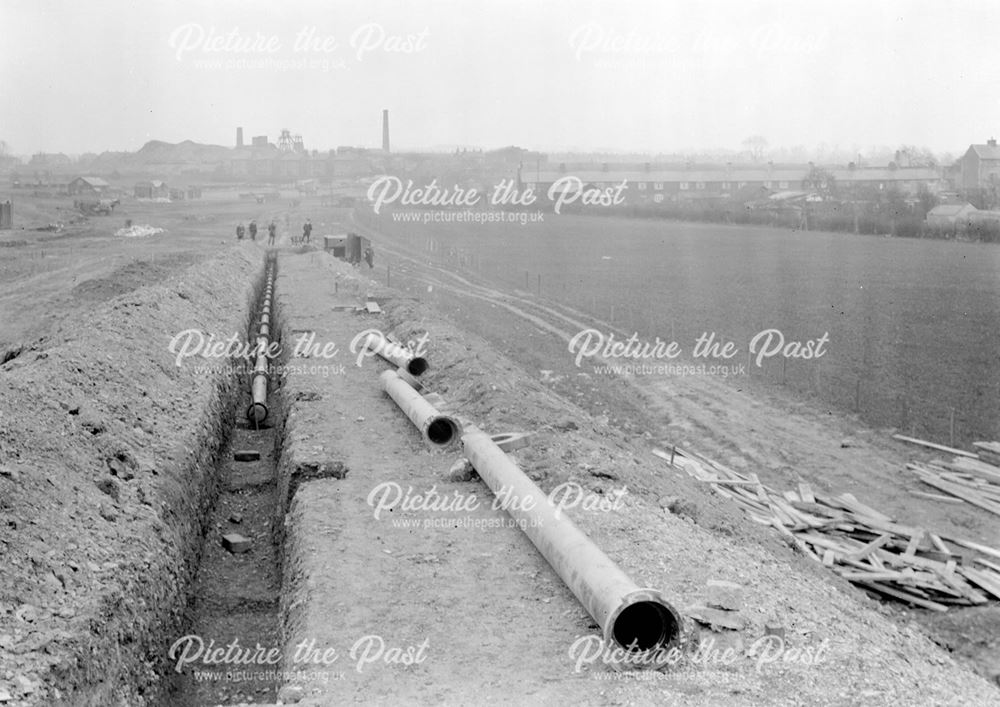 Laying water main during construction of Western Boulevard