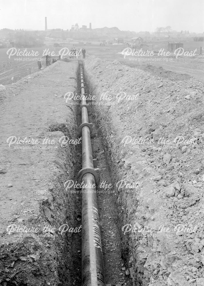 Laying water main during construction of Western Boulevard