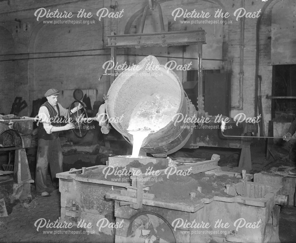 Pouring iron to make a pipe bend, Stanton Works, c 1952?
