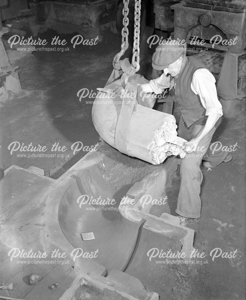 Pouring iron to make a pipe bend, Stanton Works, c 1952?