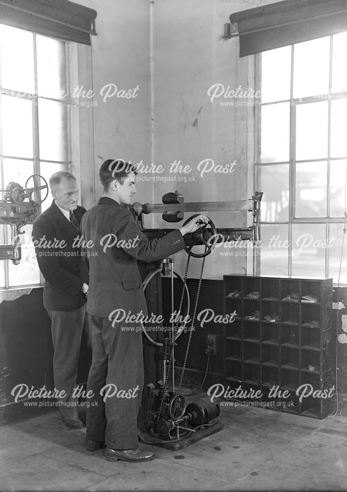 Apprentice using a tensile testing machine, Stanton Works, 1944