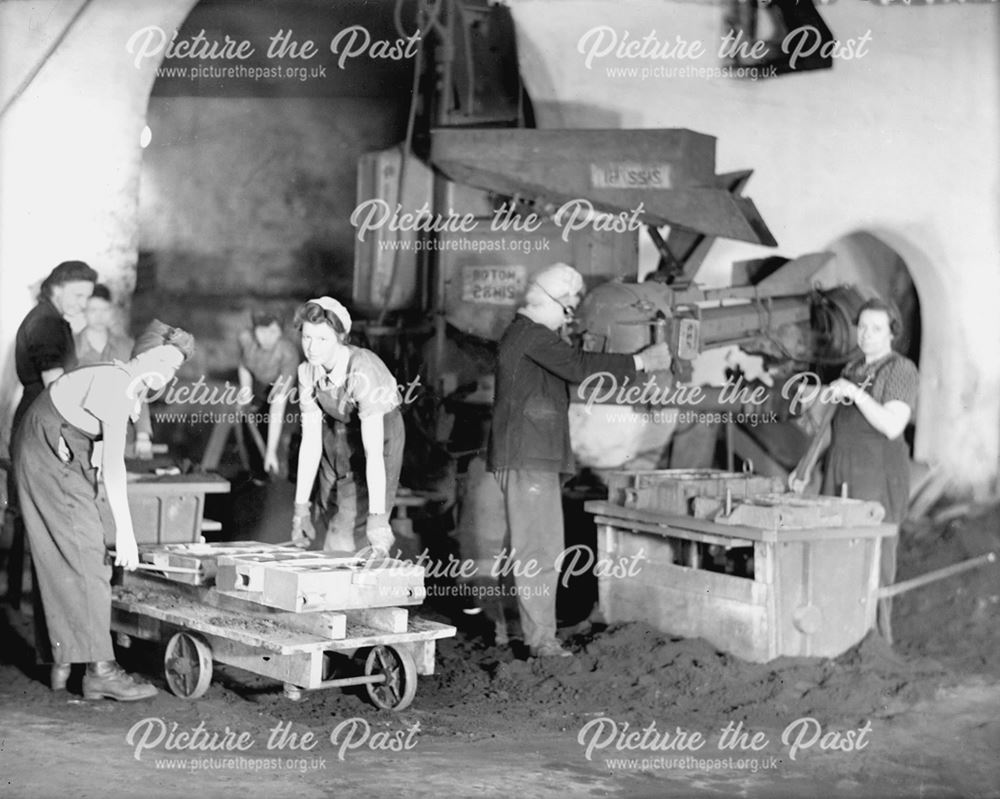 Female employees filling moulding boxes